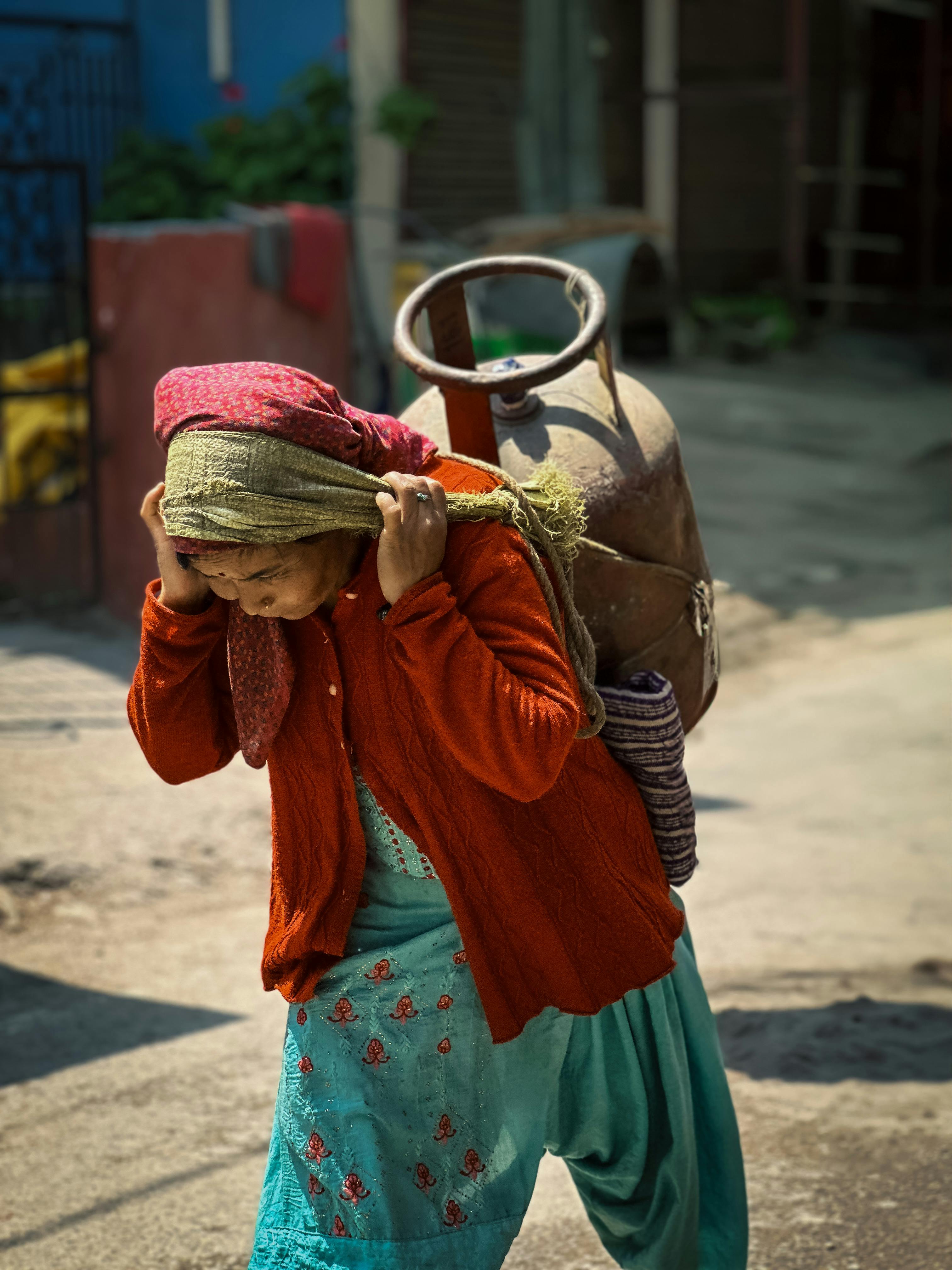 A Woman Carrying a Container on Her Back