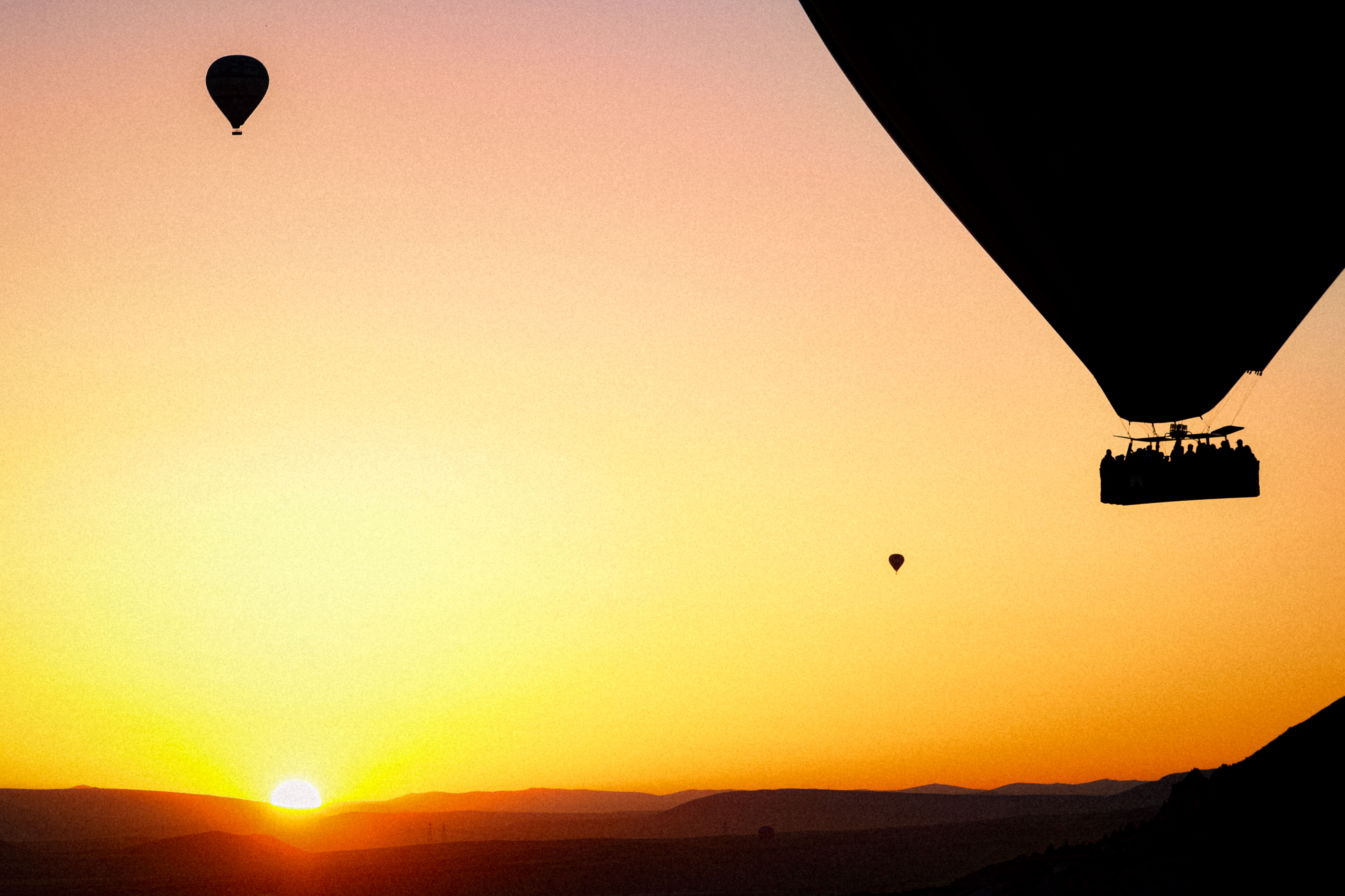 Silhouetted Hot Air Balloons Flying at Sunset · Free Stock Photo