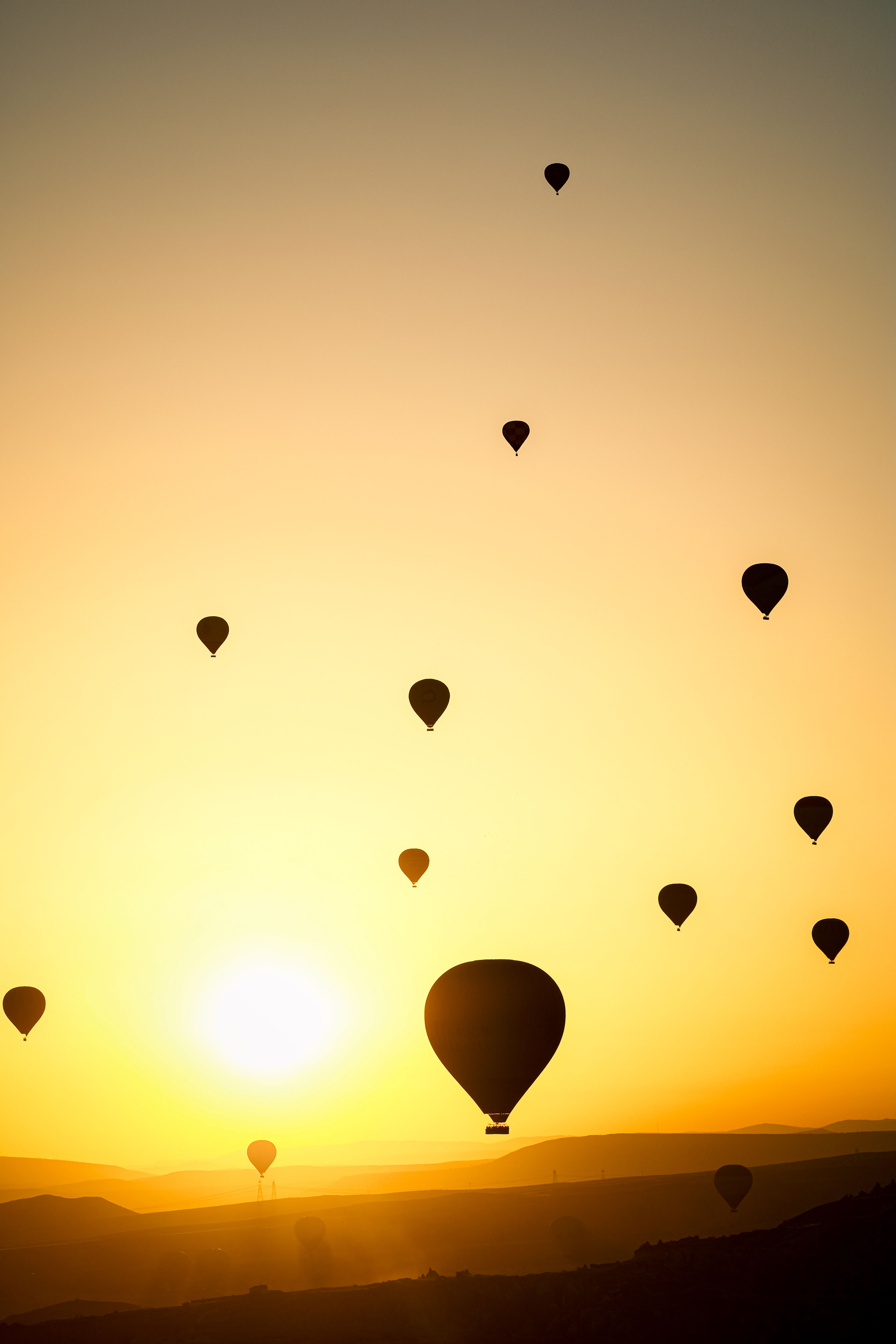 Hot air balloons flying over the sunset · Free Stock Photo