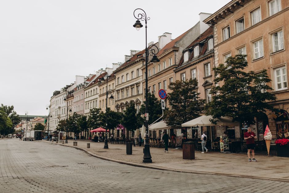 Scenic view of historic Warsaw street with colorful facades and urban charm. Ideal for travel and architecture enthusiasts.