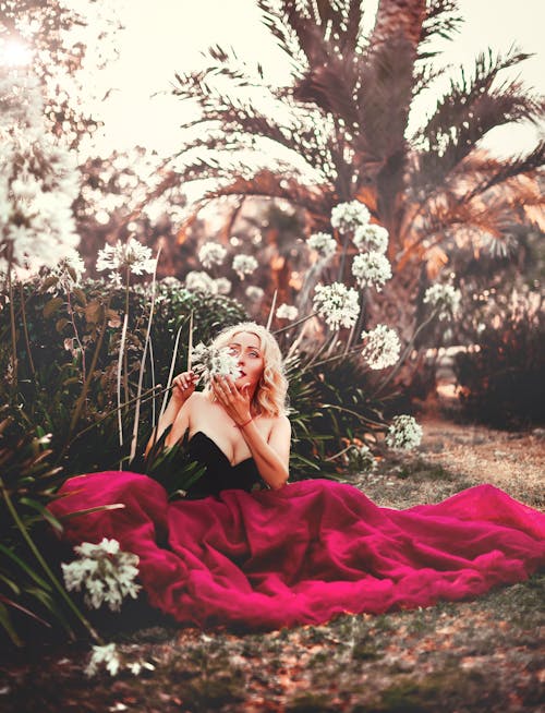 Photo of Woman Sitting Near Plants