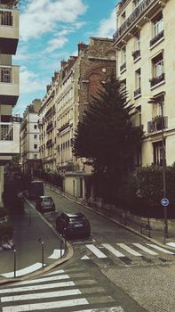 Explore a picturesque Paris street with historic buildings and classic urban charm.