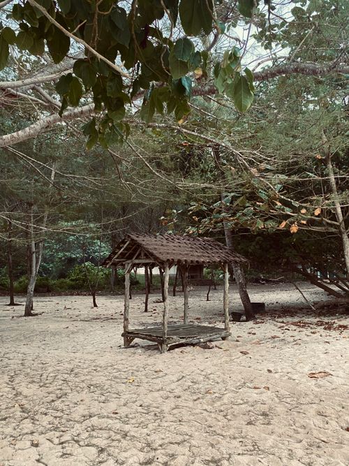 Free Rustic wooden gazebo on a serene tropical beach in Malang, Indonesia. Stock Photo