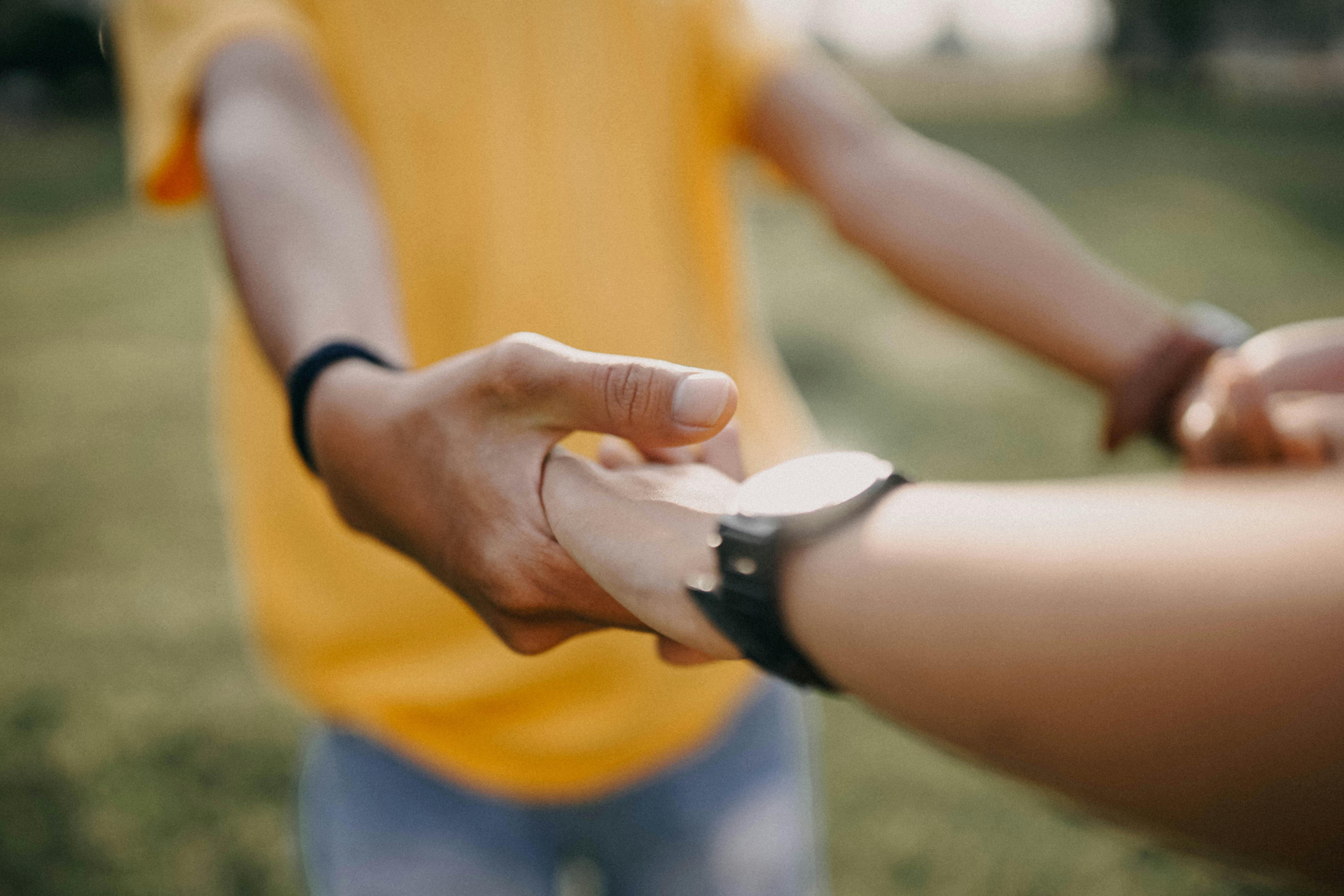 close-Up Photo of Two Person\u0026#39;s Holding Hands \u00b7 Free Stock Photo
