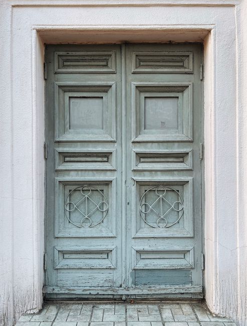 A close-up view of an old, vintage wooden door with intricate geometric designs.