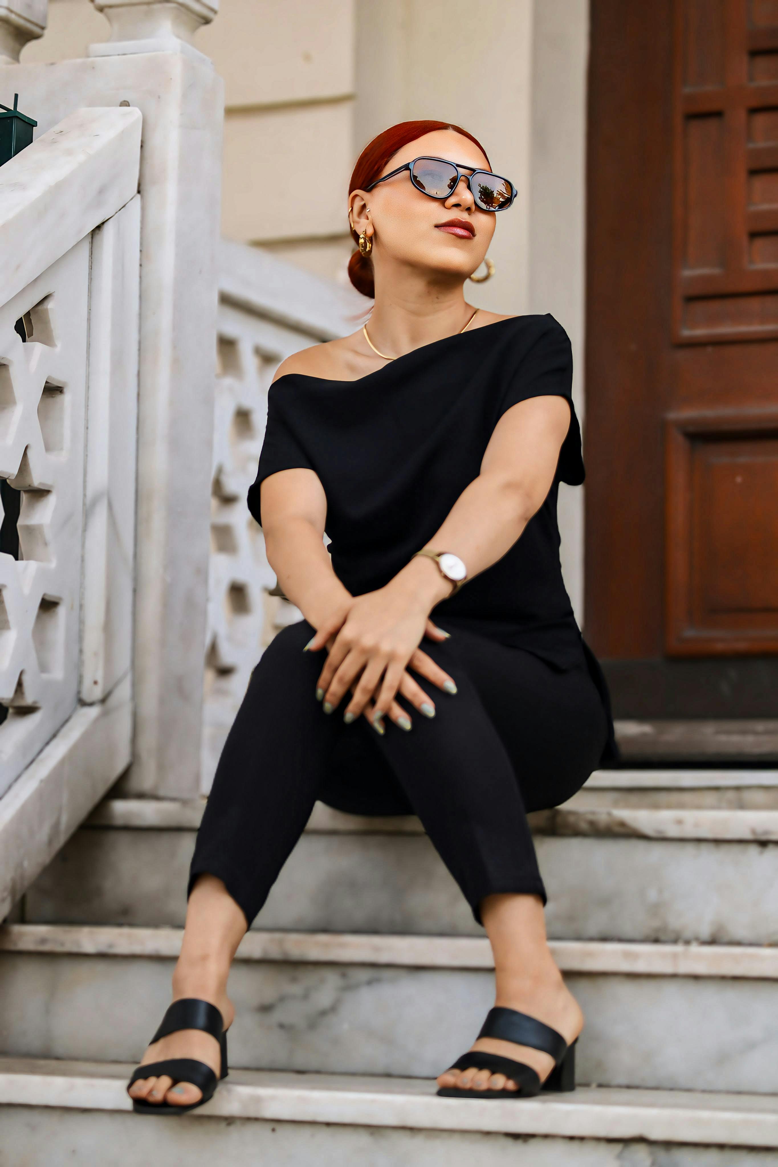 Dark sunglasses, black separates and a straight posture make street dressing feel like its own kind of performance.