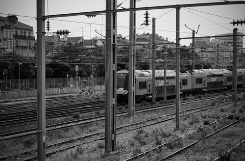 Free Black and white photograph of a train passing through Toulon's urban railway system. Stock Photo