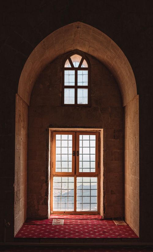 Free An elegant arched window with intricate design in Mardin, Türkiye. Captures the essence of historic architecture. Stock Photo