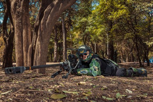 Man in Military Halo Costume Posing with Sniper Riffle on Ground