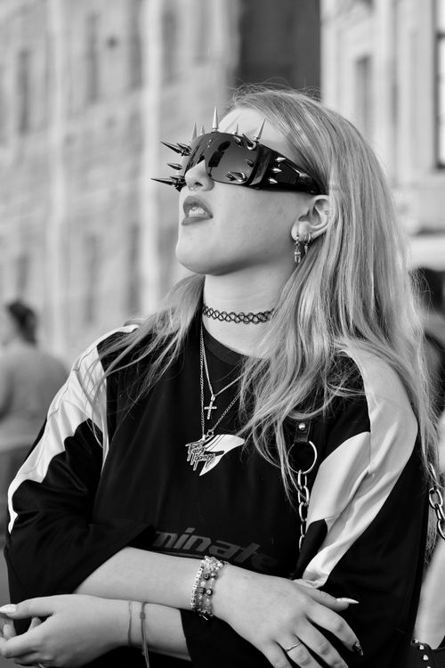 Free Black and white portrait of a woman with spiked sunglasses, embodying edgy fashion Stock Photo