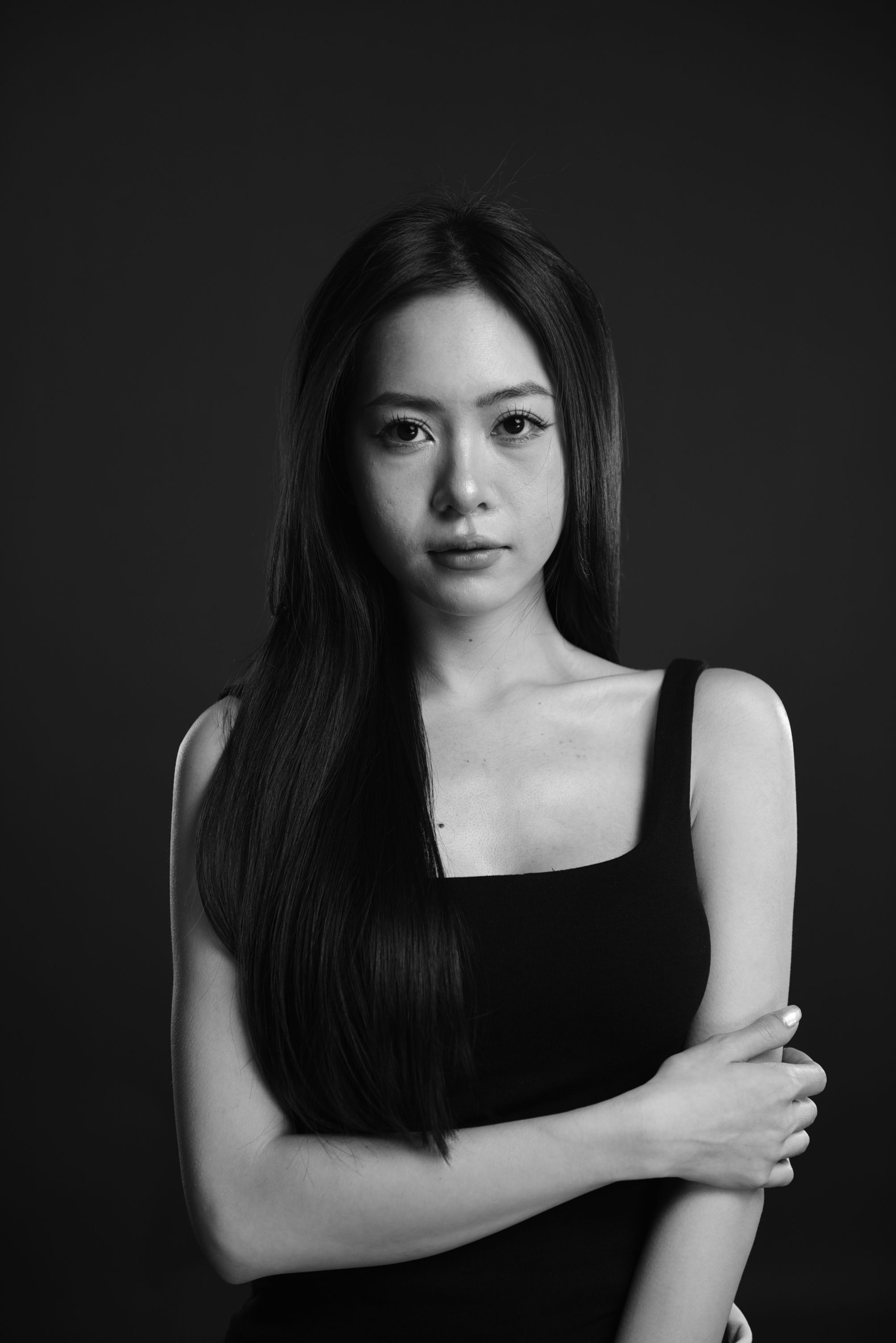 Striking black and white portrait of a woman in a studio setting.