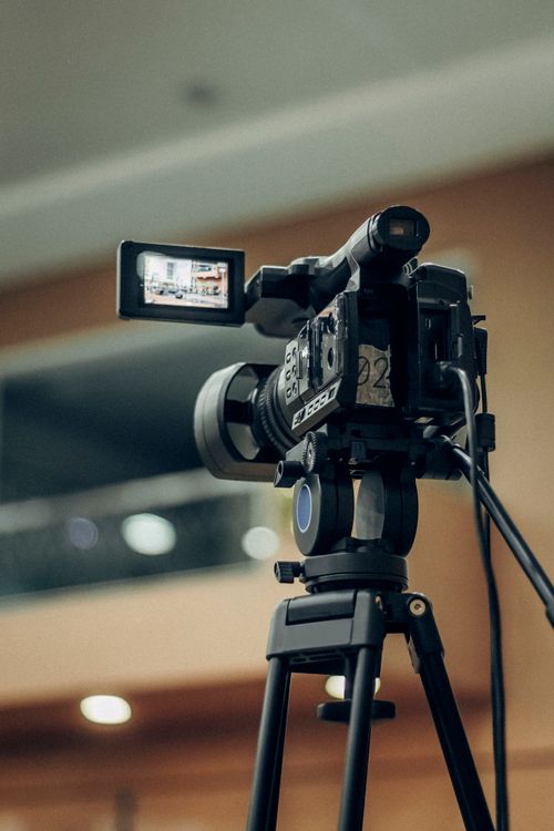 Video camcorder on tripod for recording and streaming