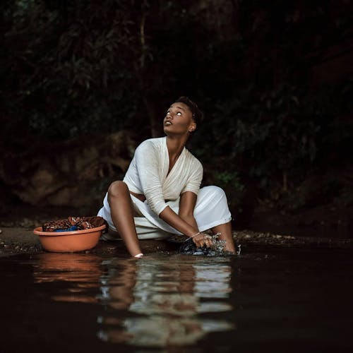 Photo of Woman Sitting Near Water