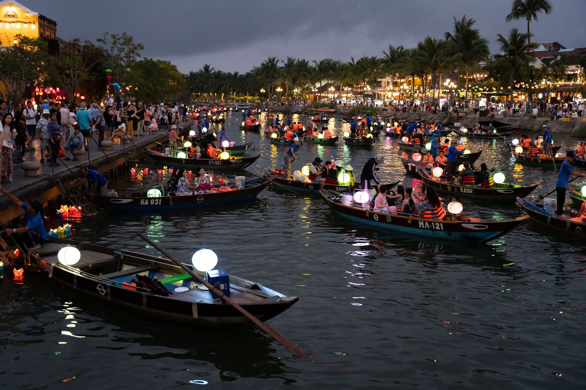 Boats filled with glowing lanterns during the traditional festival in Hội An, Vietnam, offering a vibrant cultural experience.