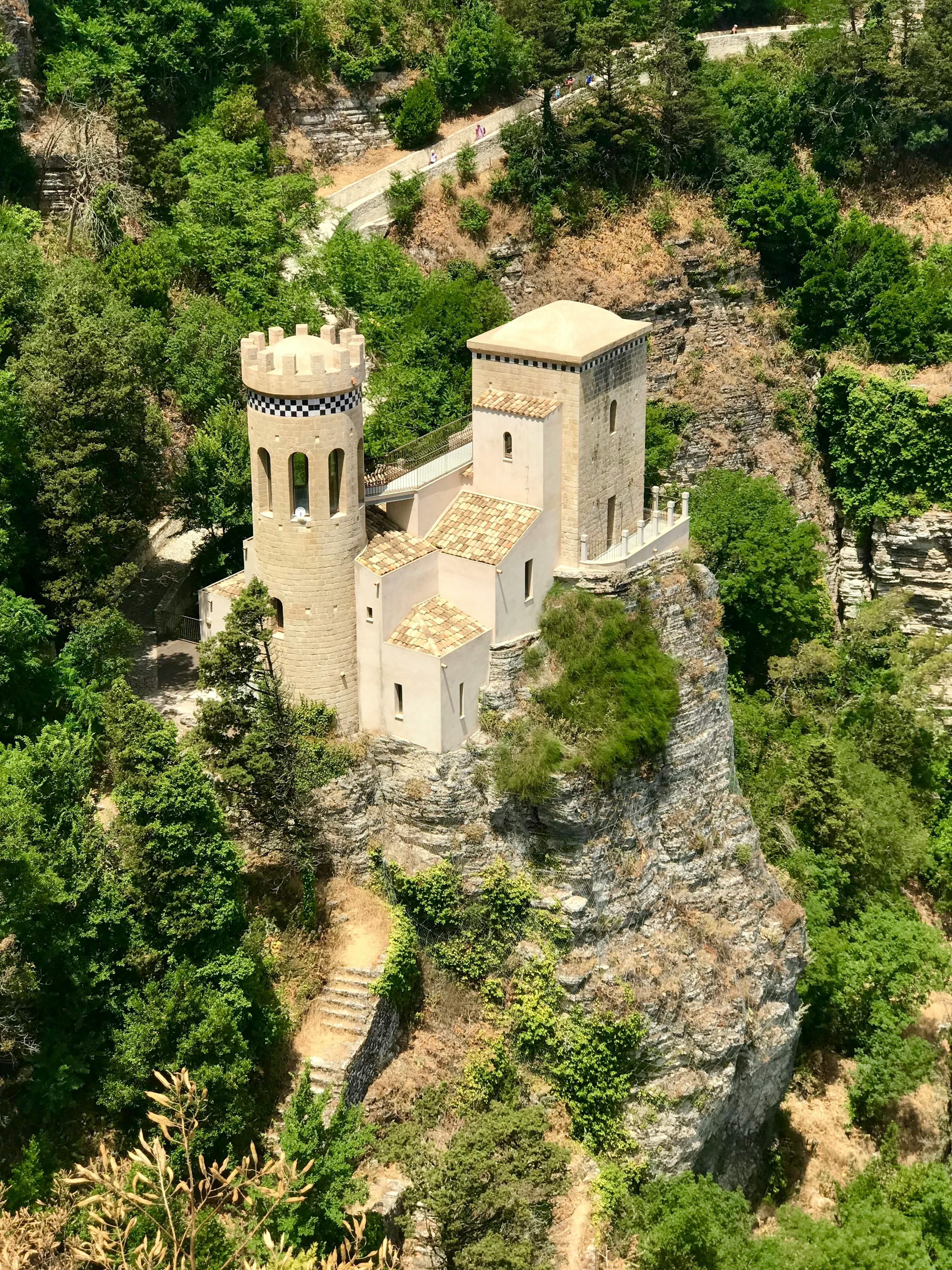 Aerial view of Torretta Pepoli Castle surrounded by lush greenery in Erice, Sicily, Italy.