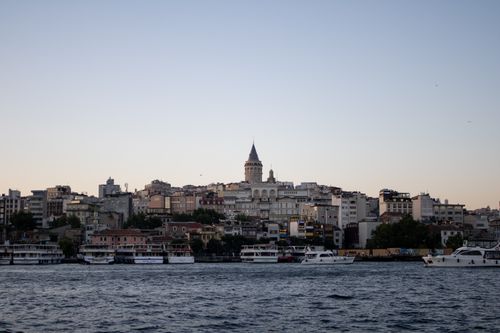 Free A stunning view of the Galata Tower and surrounding cityscape in Istanbul at sunset. Stock Photo