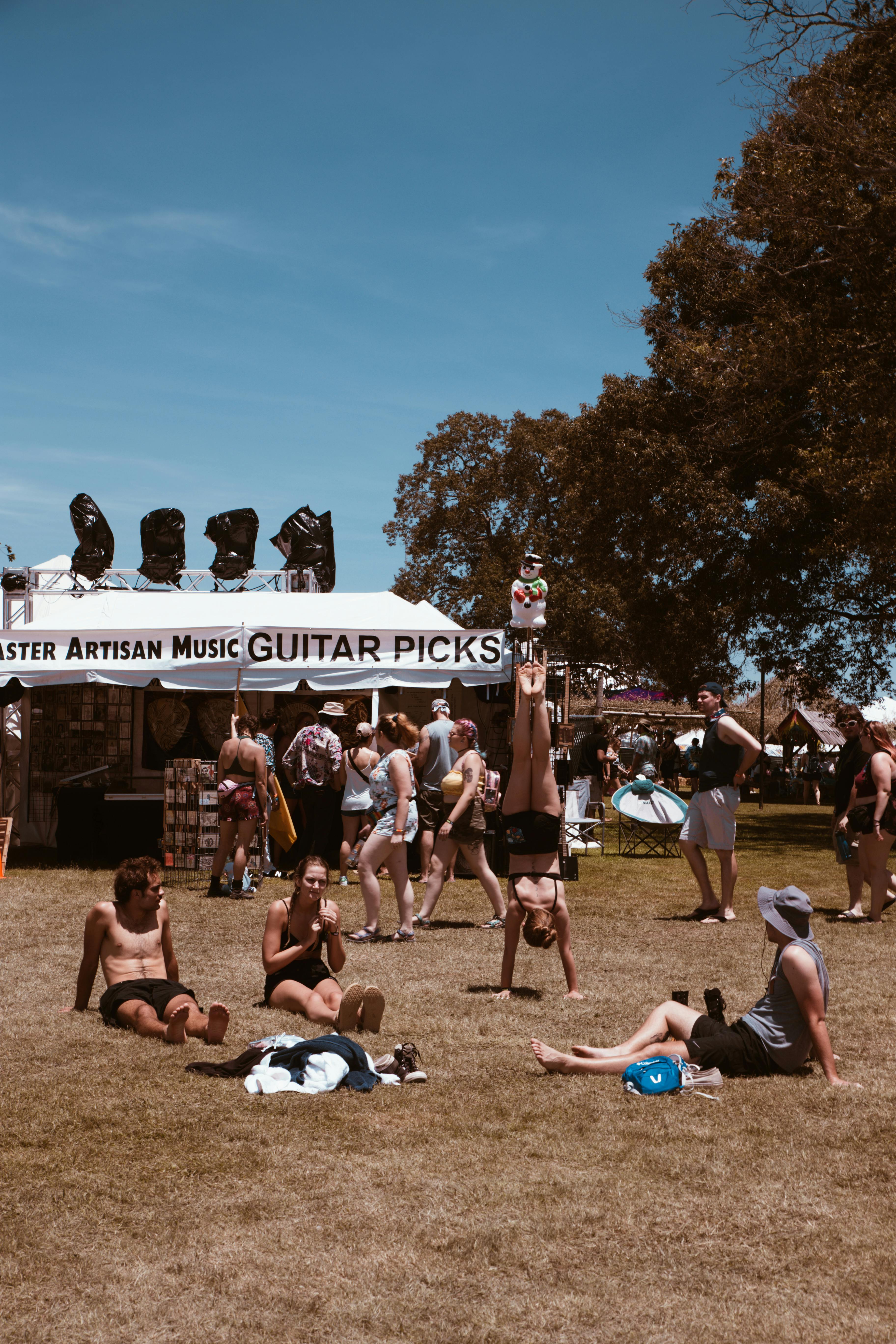 photo of people sitting on grass