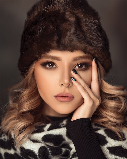 Free Woman Wearing Brown Fur Beanies and White and Balck Top Stock Photo