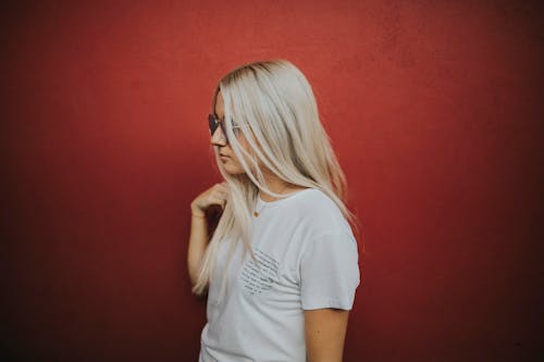 Photo of Woman Standing on Red Background