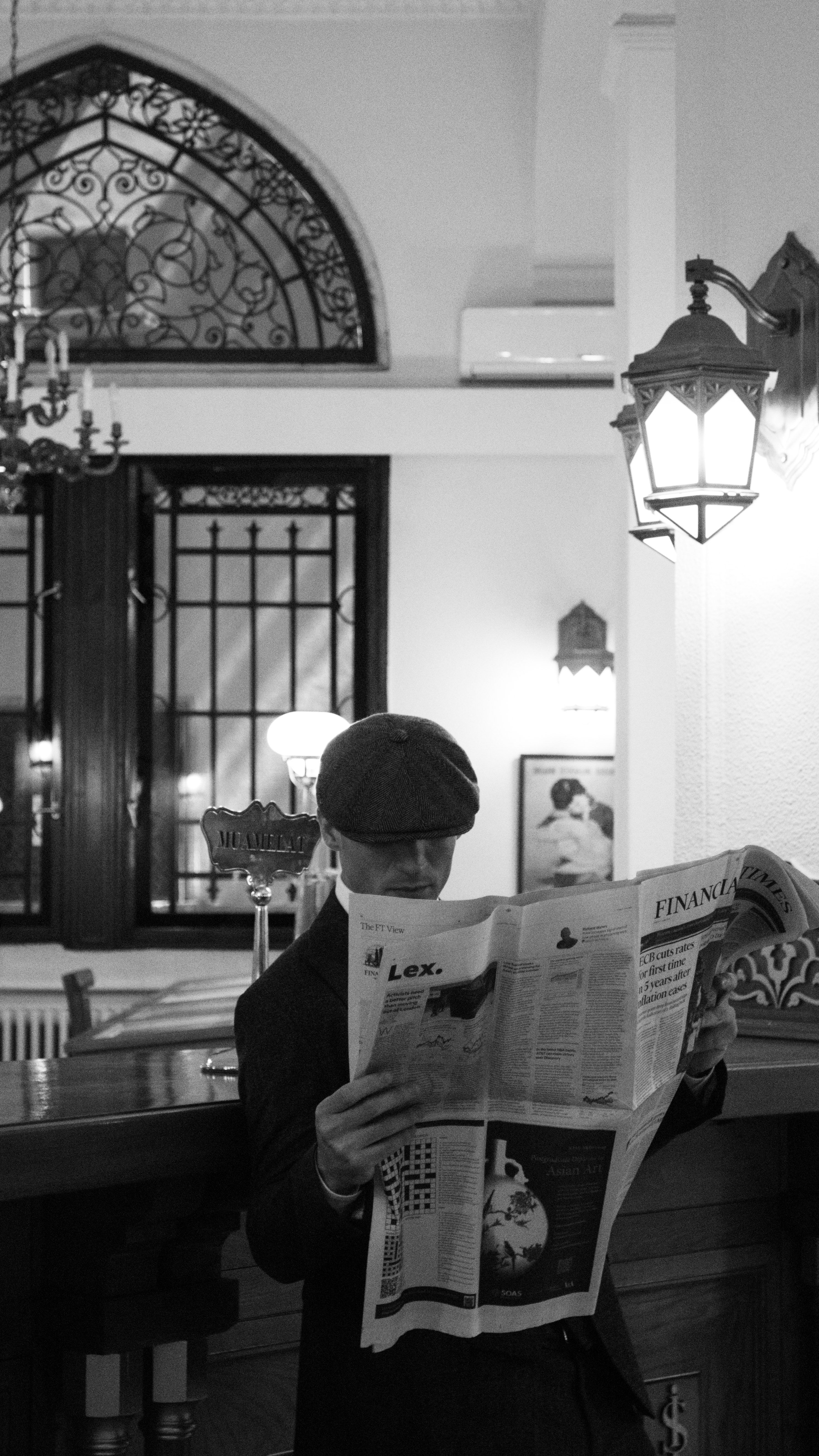 elegant man reading a newspaper in black and white
