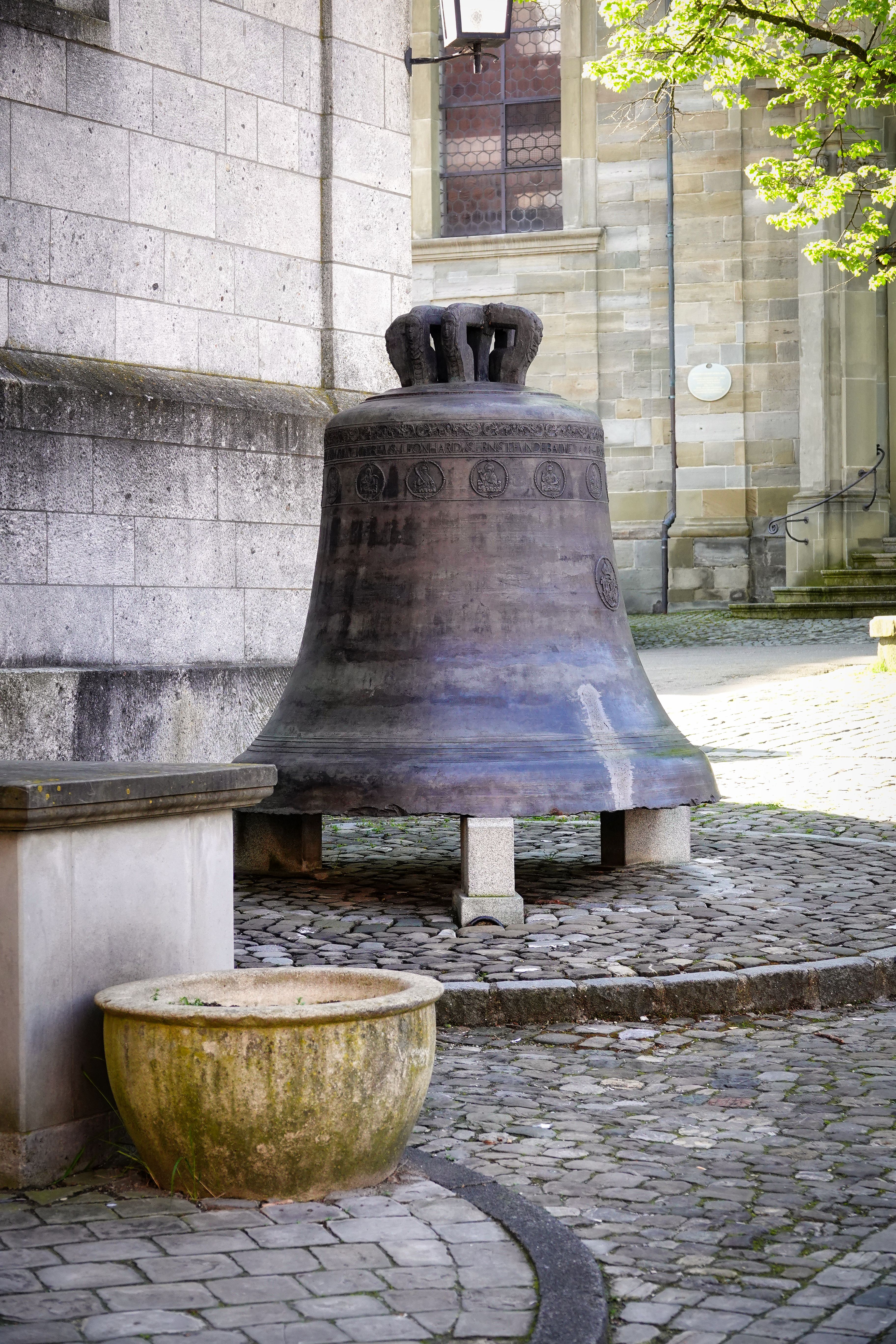 A vintage bell displayed outdoors in Lindau, Germany, showcasing classic architecture.