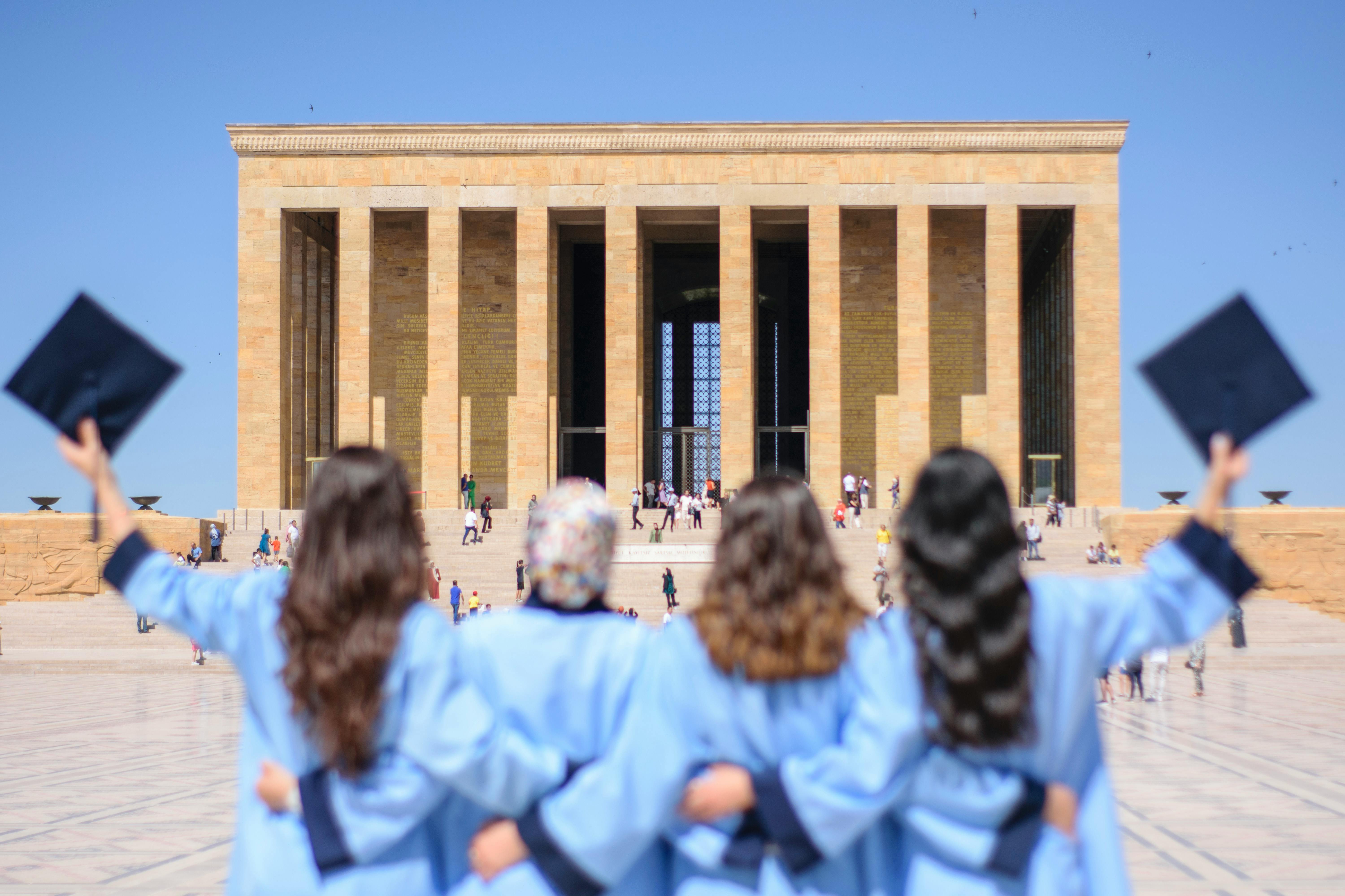 Women in graduation gowns stand in front of Anıtkabir, Ankara, June 27, 2024. (Photo via Pexels)