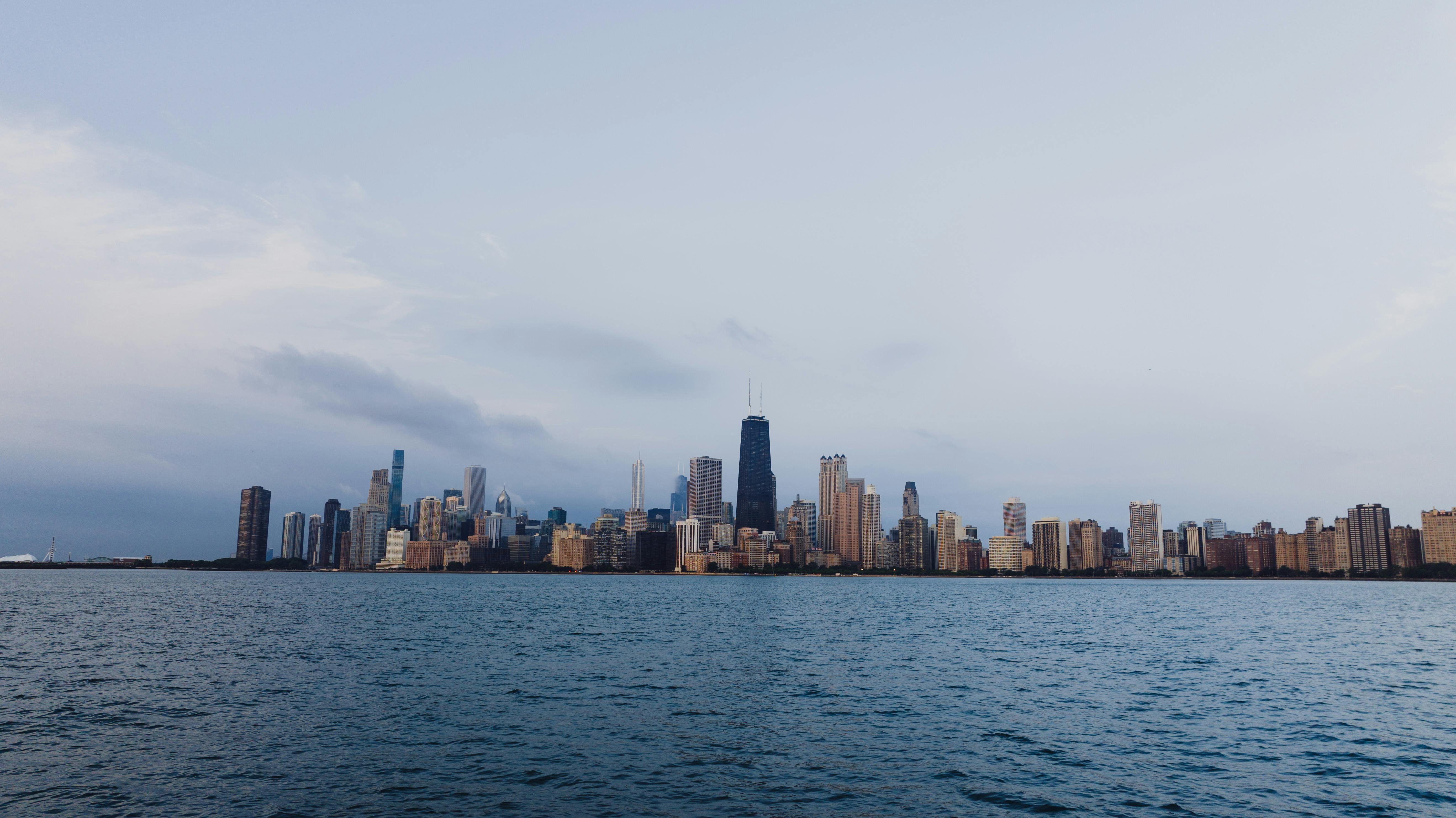 Scenic View Of City Under Cloudy Sky · Free Stock Photo