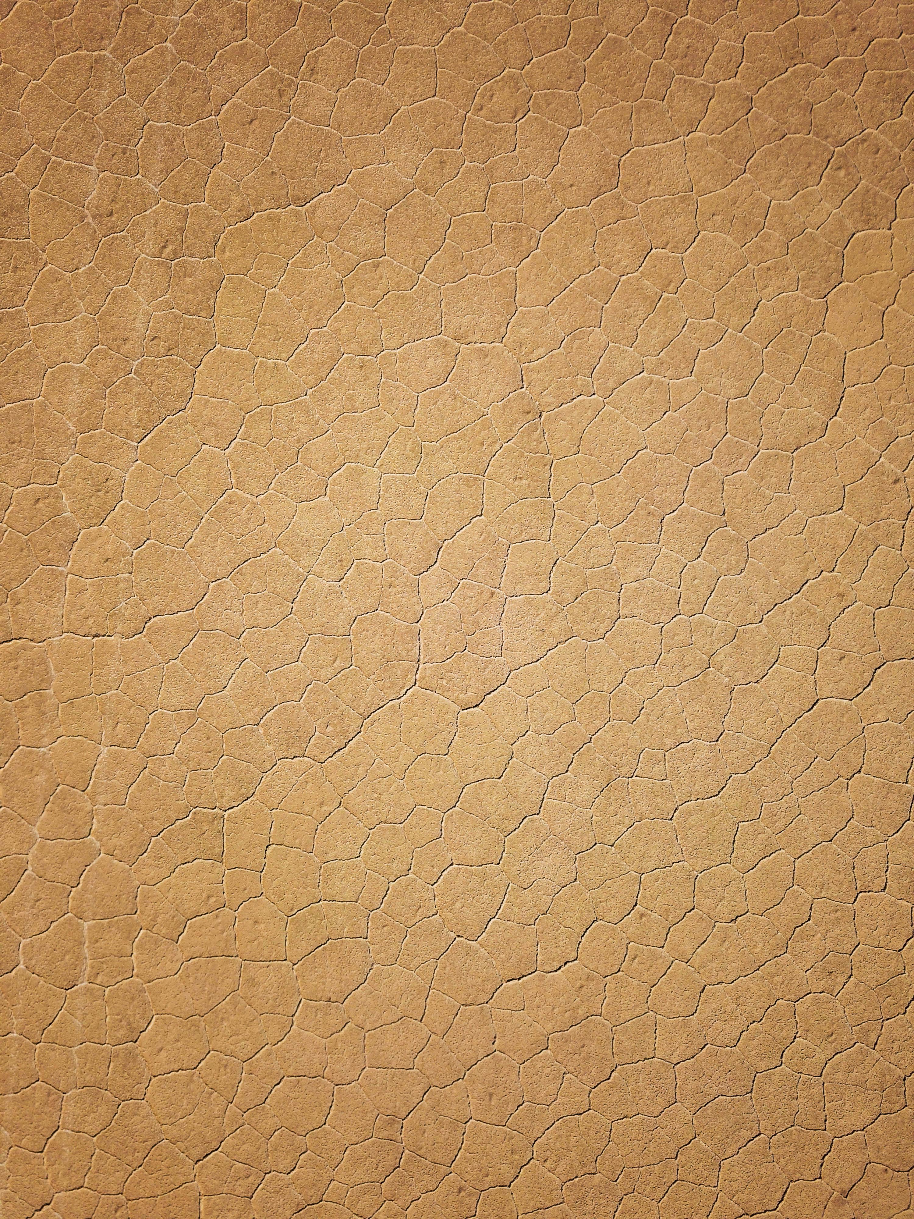 Free Cracked earth texture resembling a desert landscape in Damghan, Iran. Stock Photo
