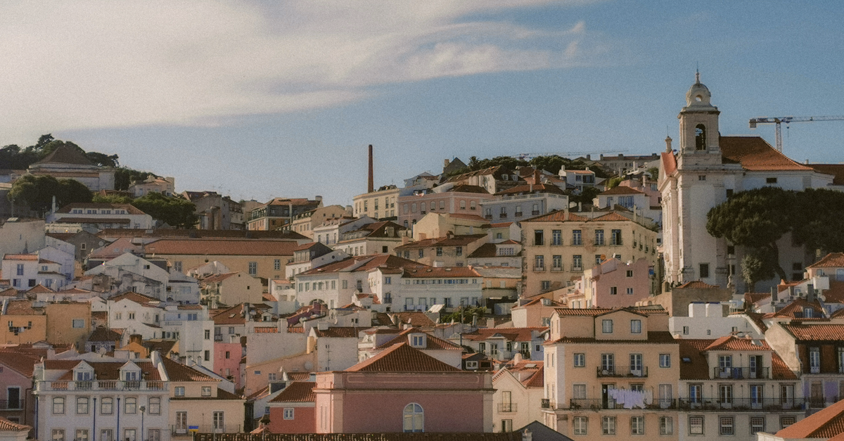 Aerial view of Lisbon's charming historic architecture under a bright sky.
