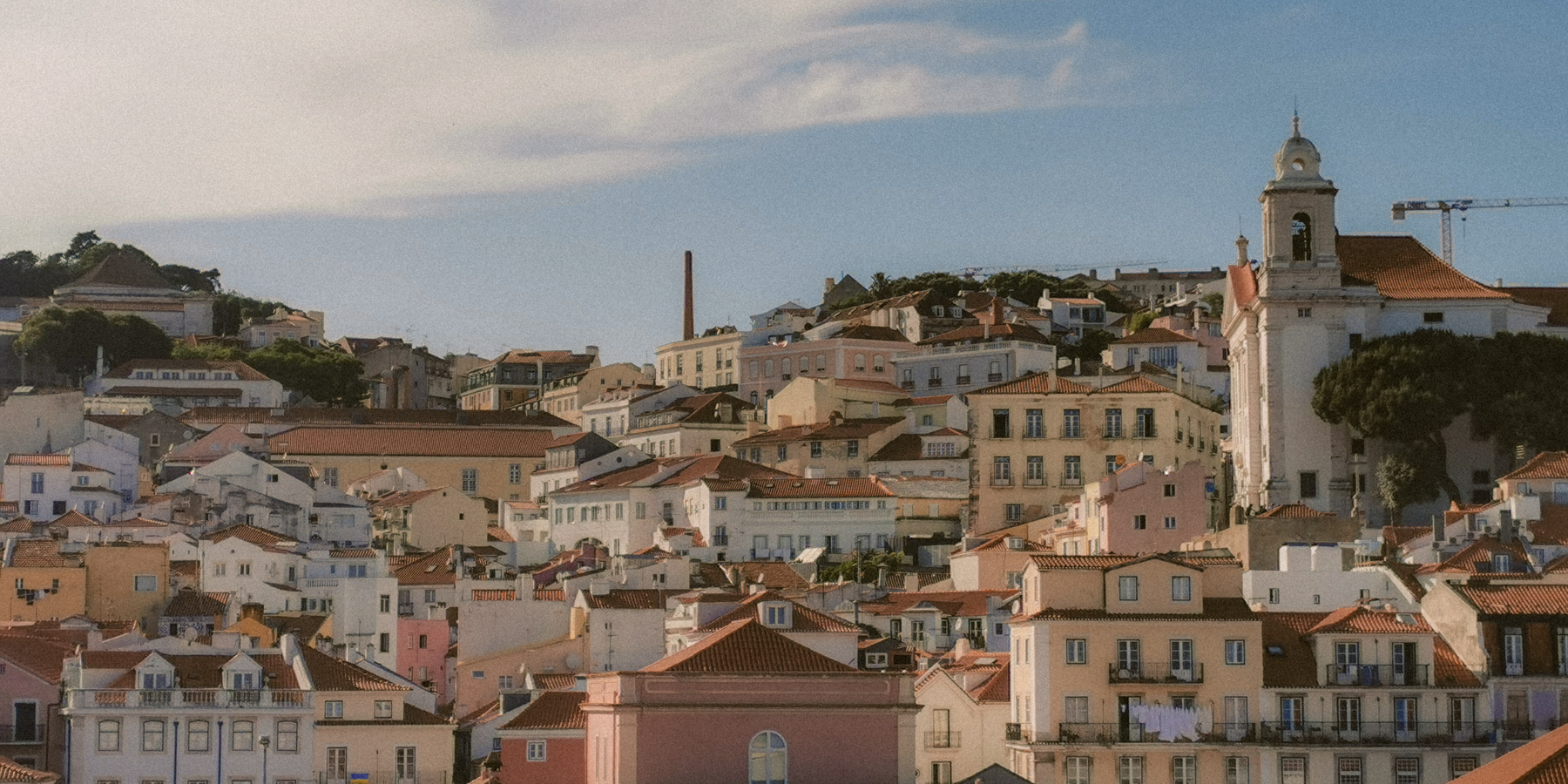 Aerial view of Lisbon's charming historic architecture under a bright sky.