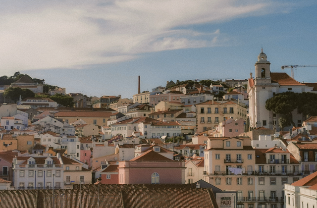 Aerial view of Lisbon's charming historic architecture under a bright sky. — arriving in Lisbon