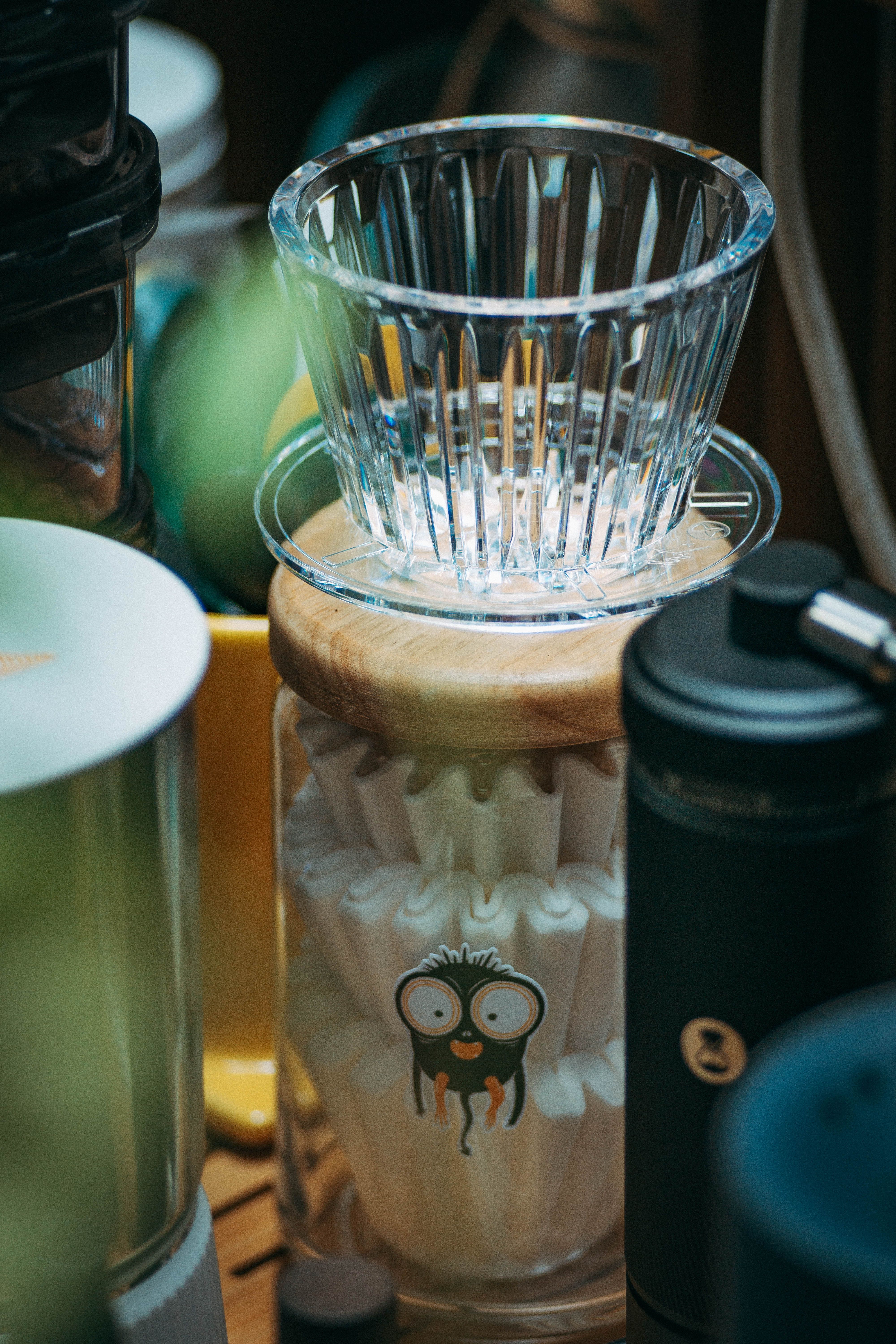 clear glass apothecary jar filled with brown paper coffee filters on a kitchen counter