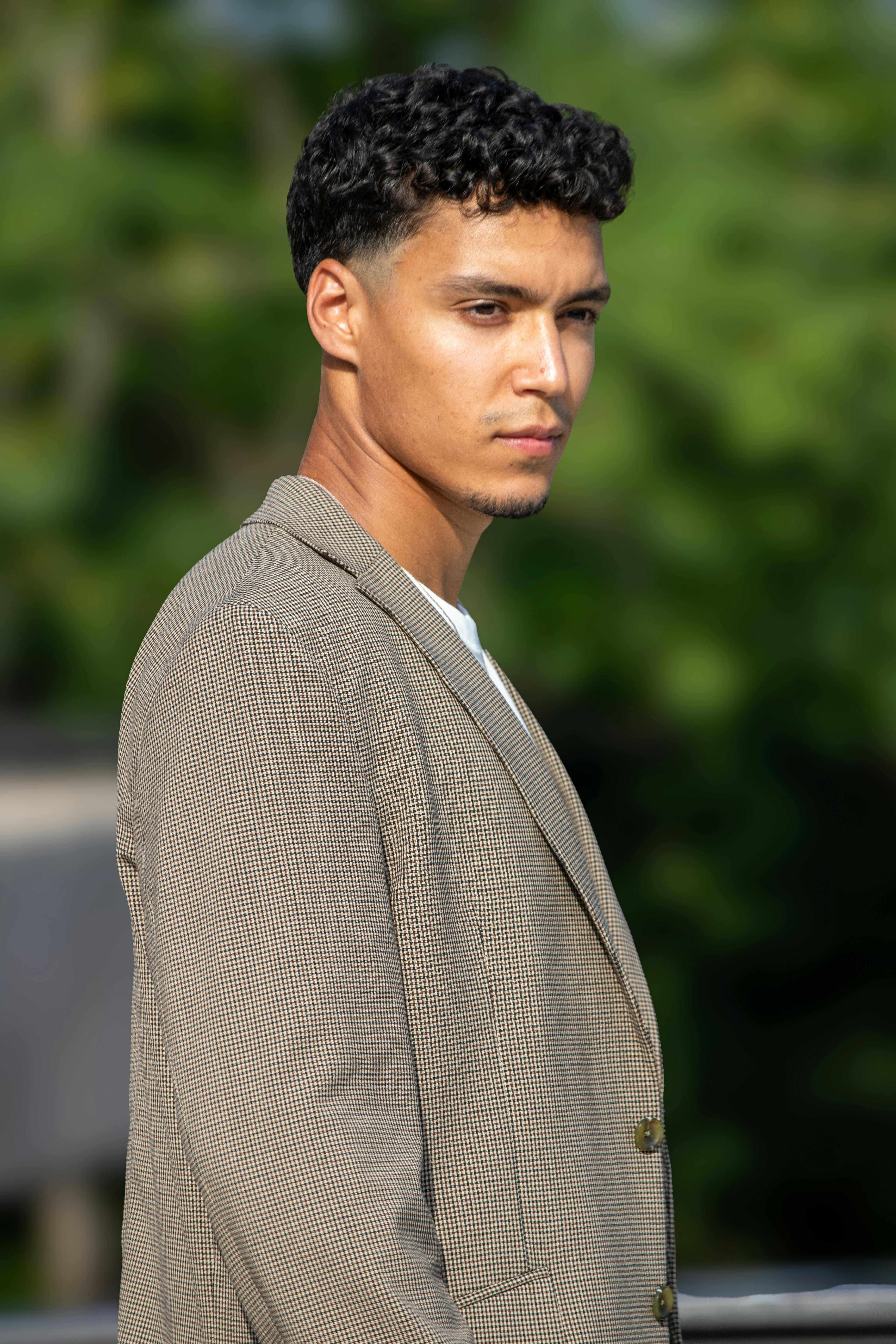 Elegant portrait of a young man in a jacket, captured outdoors in Berlin.