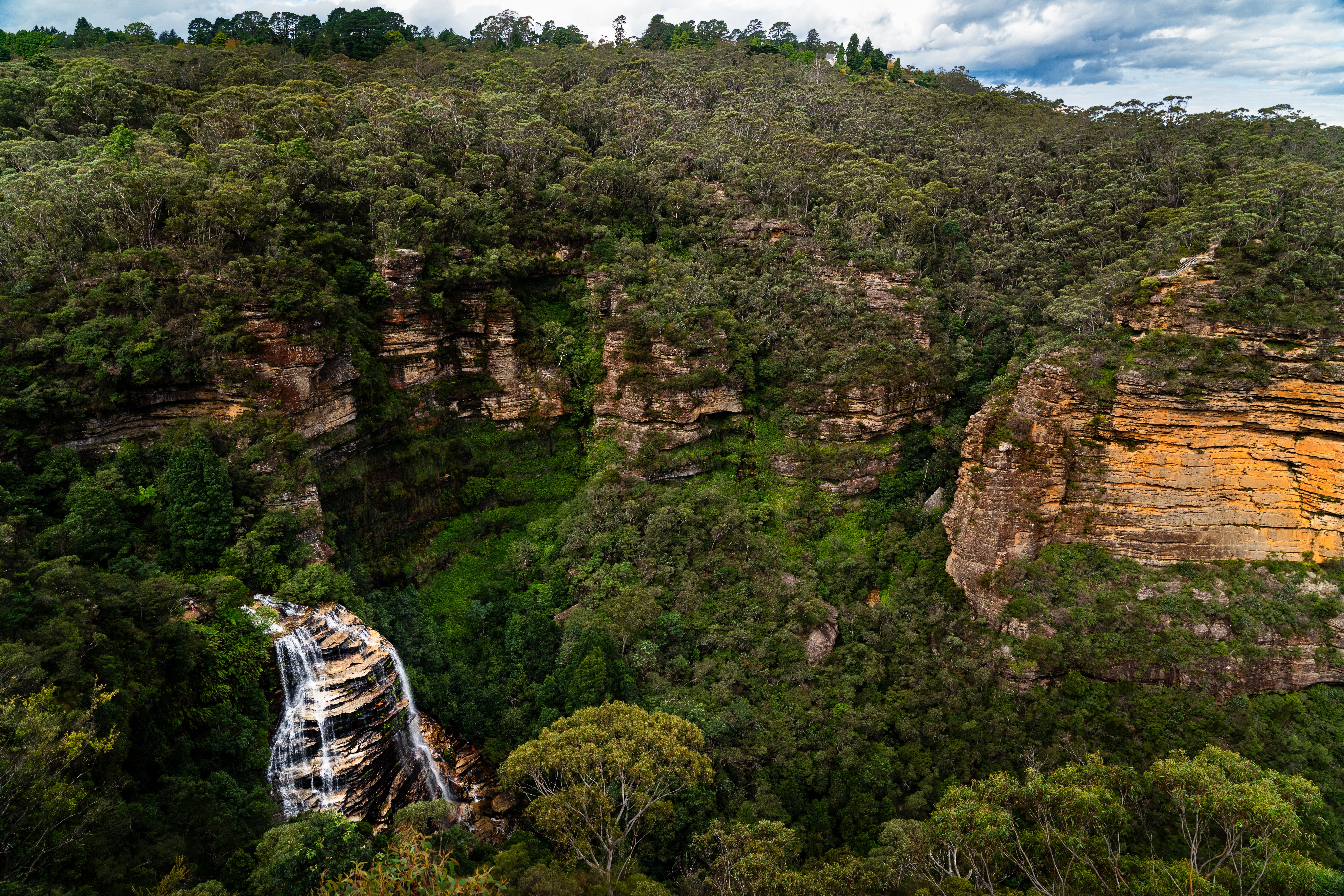 Explore the stunning landscape of the Blue Mountains with a breathtaking waterfall.