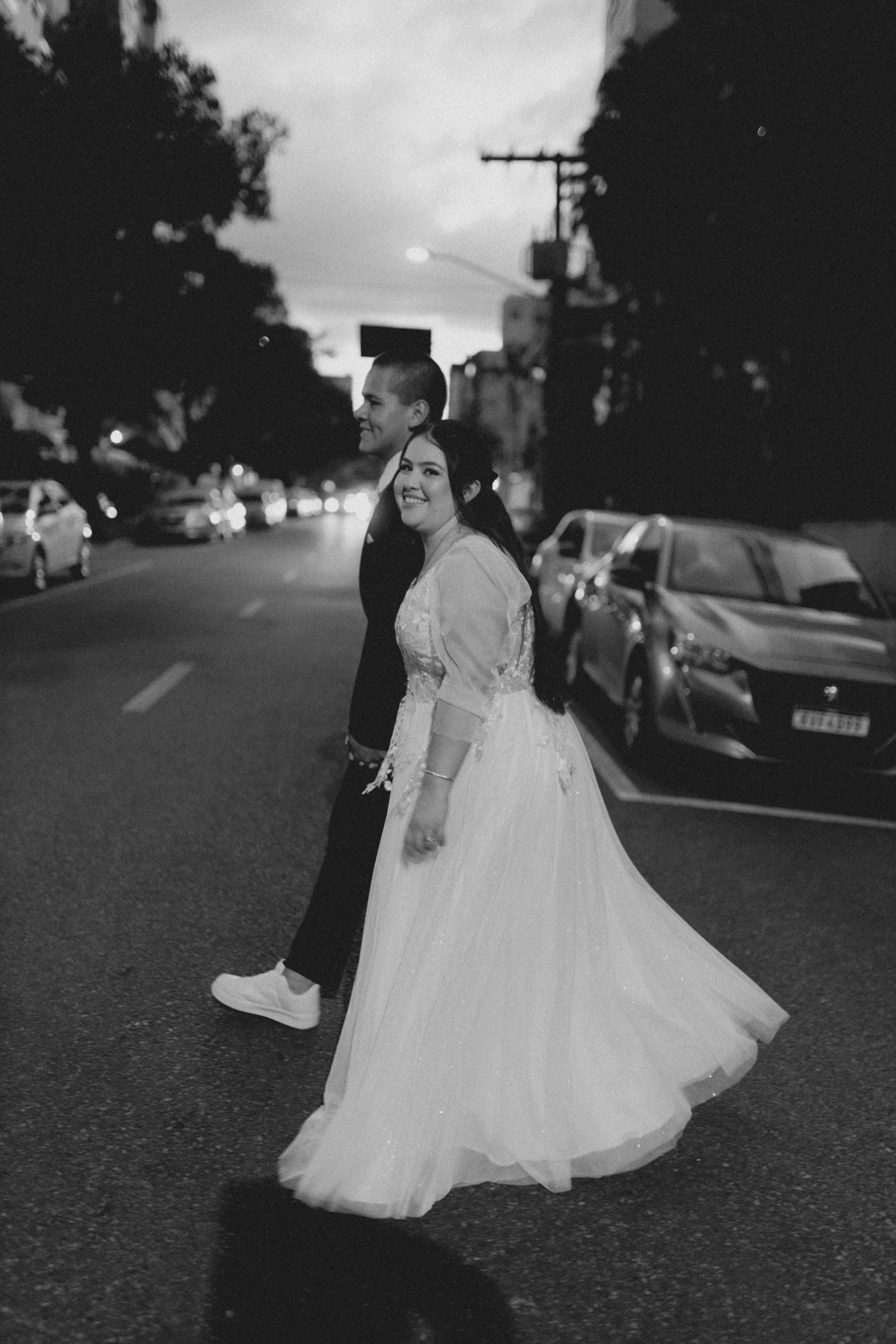 smiling newlyweds crossing street