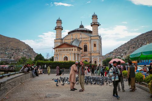 Free Tourists capturing moments at the historic Shah-Do Shamshira Mosque in vibrant Kabul, Afghanistan. Stock Photo