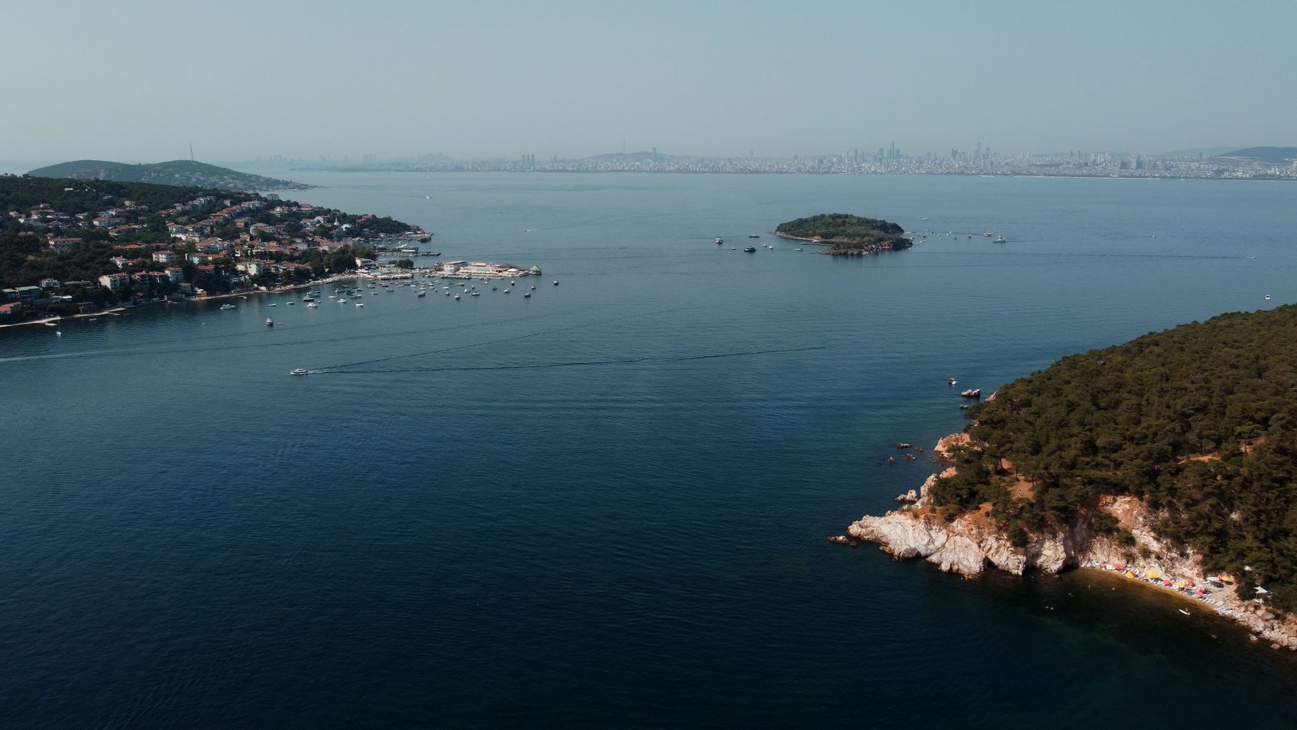 Breathtaking aerial shot of Heybeliada island with Istanbul skyline, capturing rich waters and coastline.