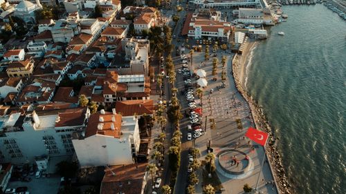 Free Charming aerial view of Kuşadası's waterfront, featuring architecture and vibrant harbor life during sunset. Stock Photo
