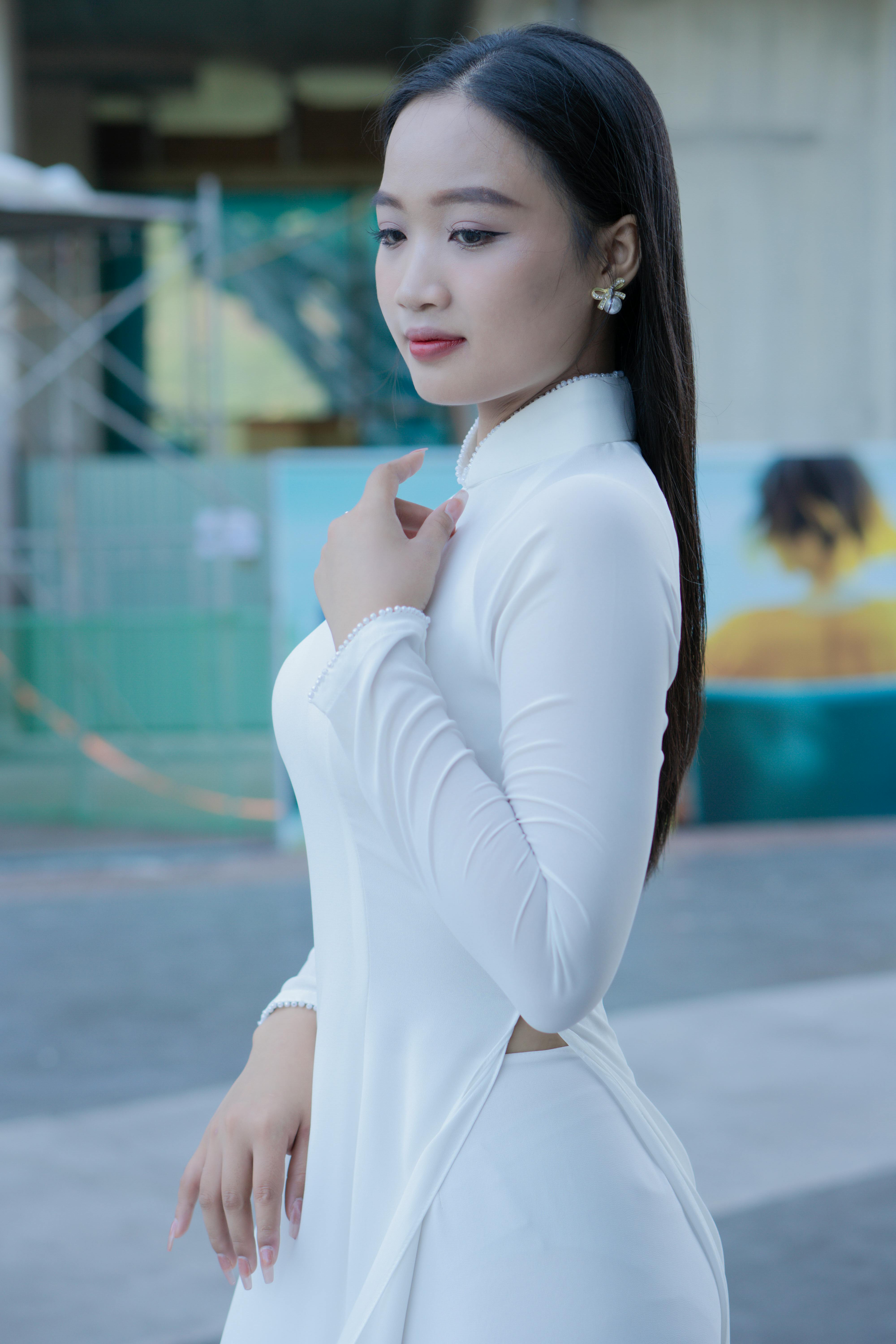 A graceful woman wearing a white ao dai, capturing elegance and traditional fashion.