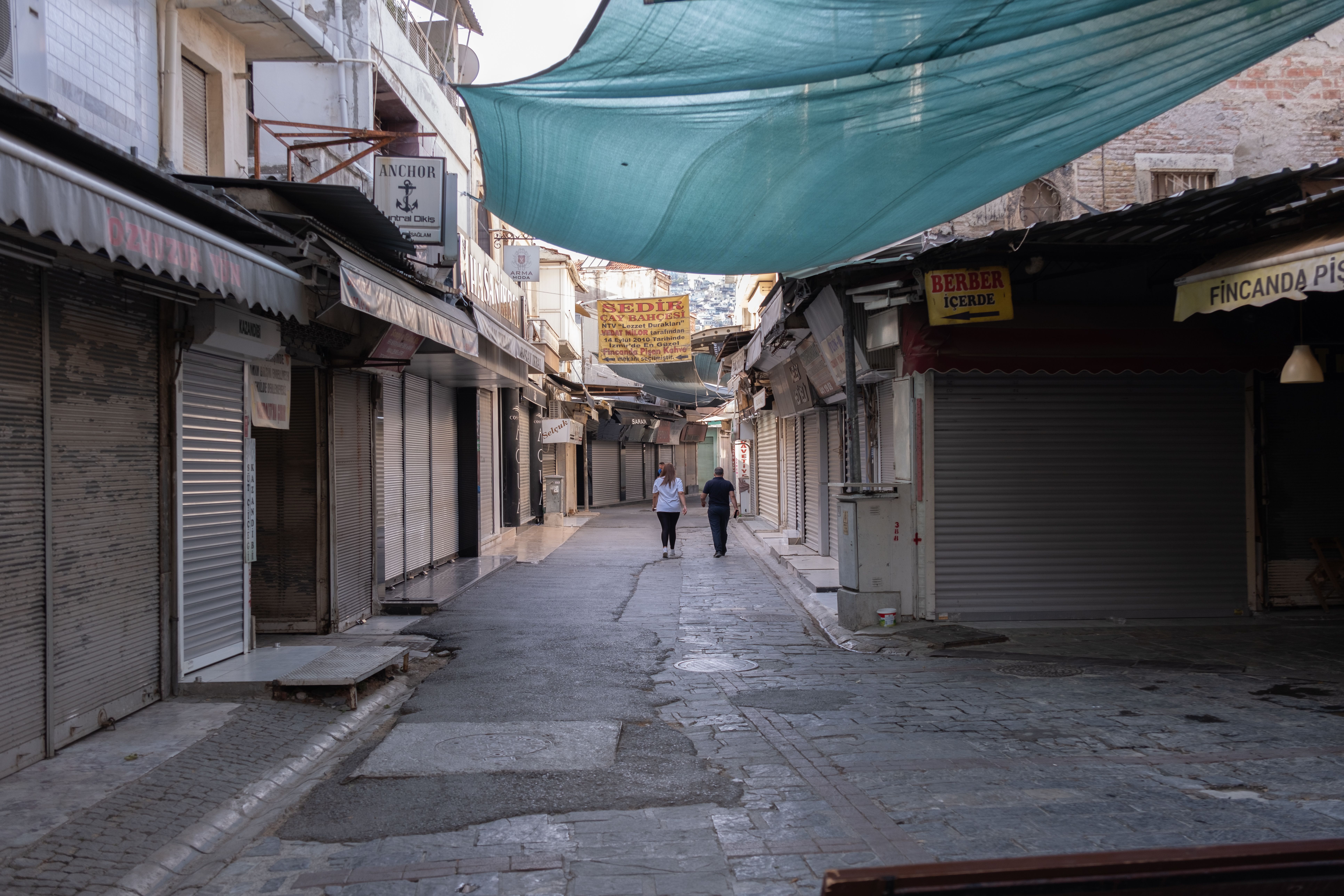 traveler walking through quiet local market street in morning light