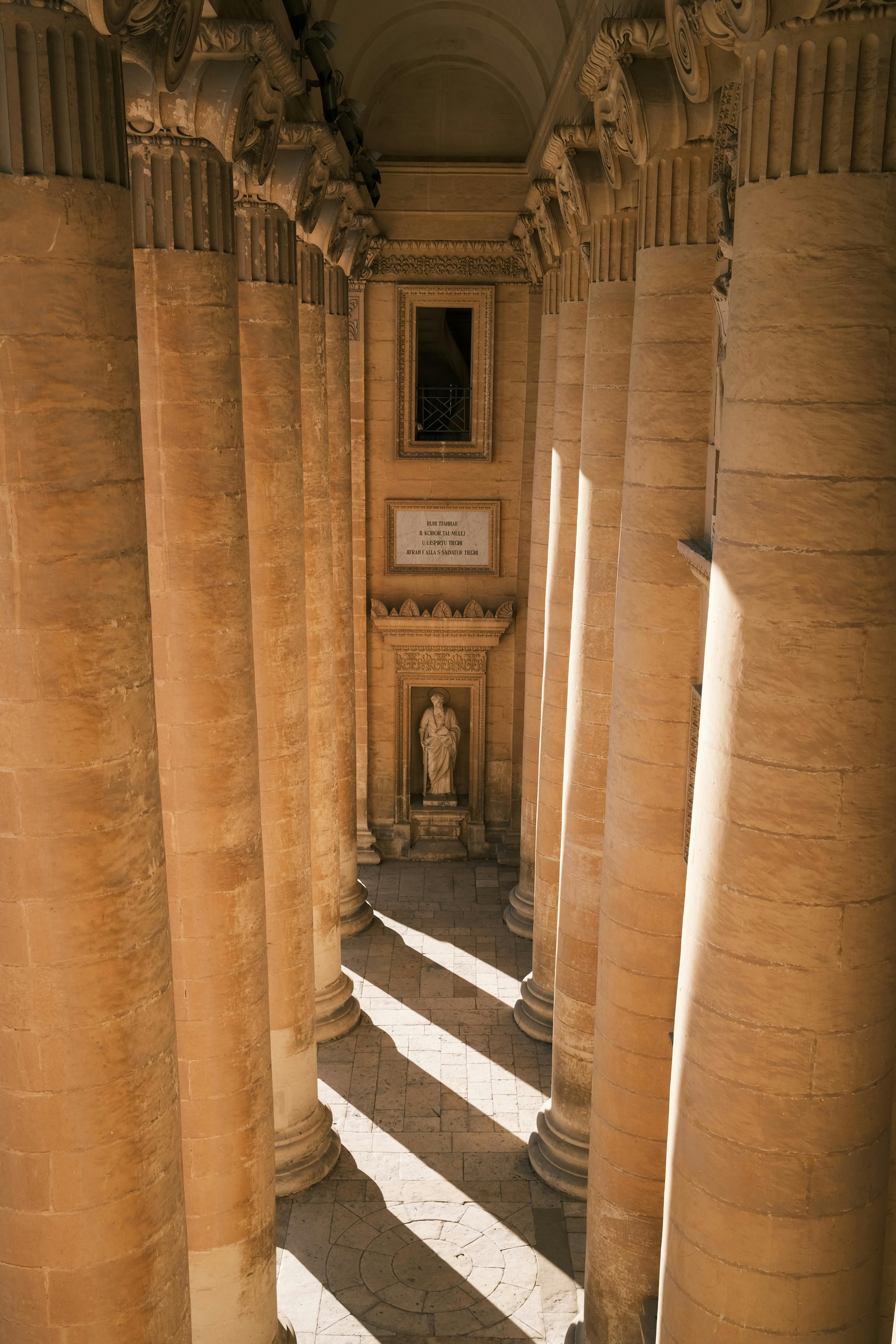 Elegant classical columns in Mosta Dome, Malta, showcasing grand architectural heritage.