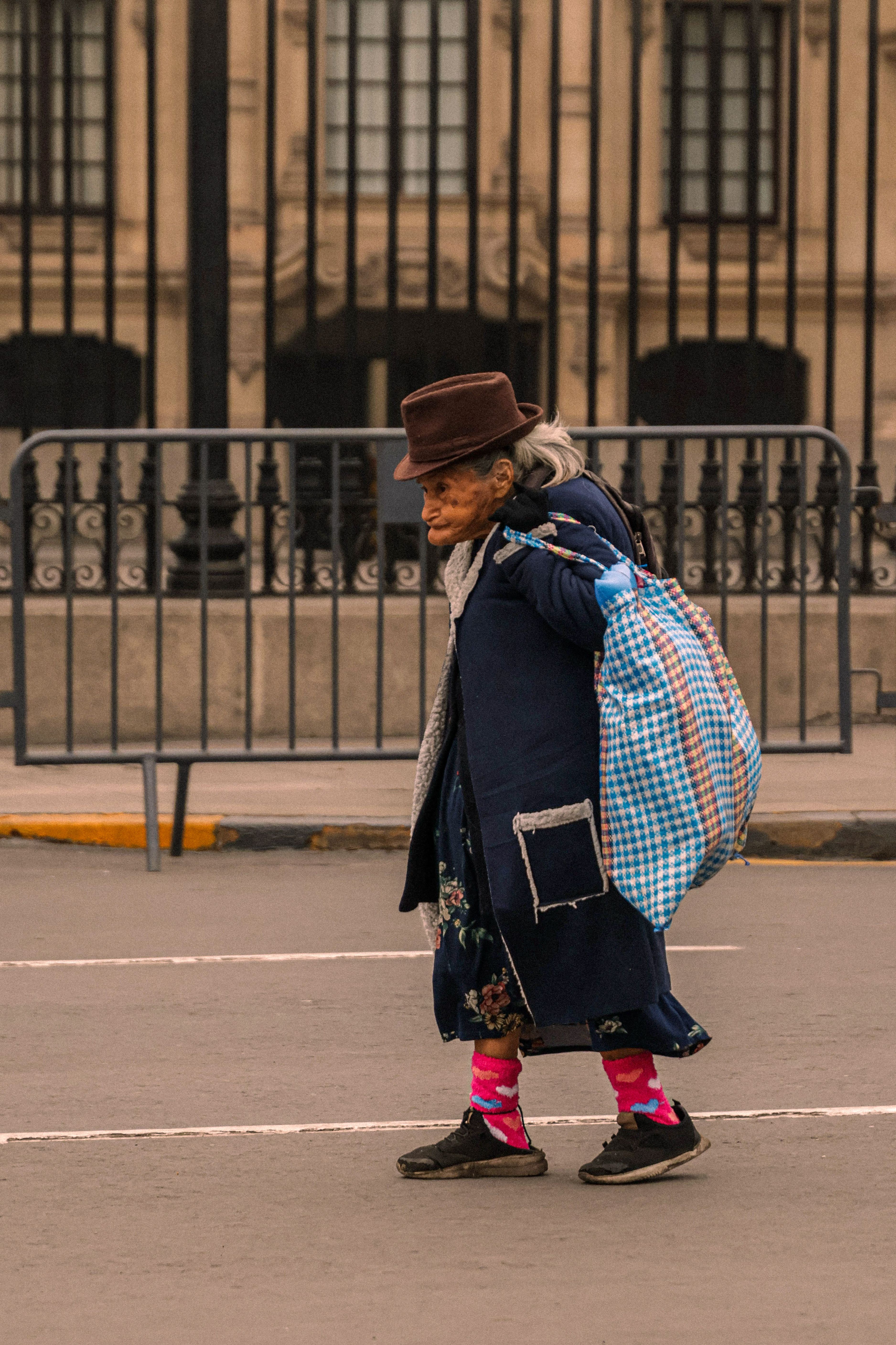 Photo of an Elderly Woman Walking on the Street · Free Stock Photo