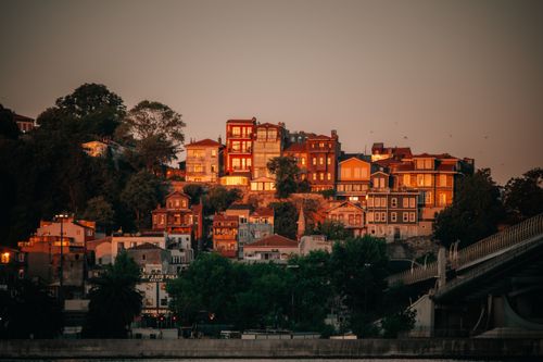 Free Charming hillside view of residential buildings and bridge at sunset. Stock Photo