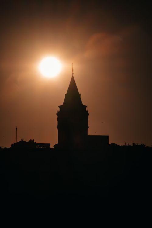 Free A striking silhouette of Galata Tower against a vibrant sunset sky in Istanbul. Stock Photo
