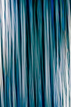 Ethereal abstract art with flowing blue vertical lines for a creative backdrop.