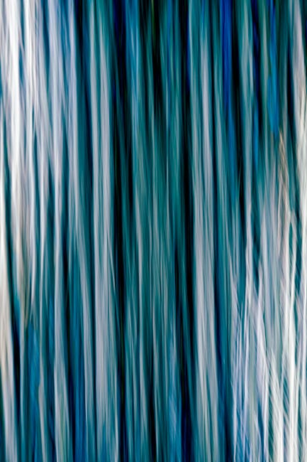 Ethereal abstract art with flowing blue vertical lines for a creative backdrop.