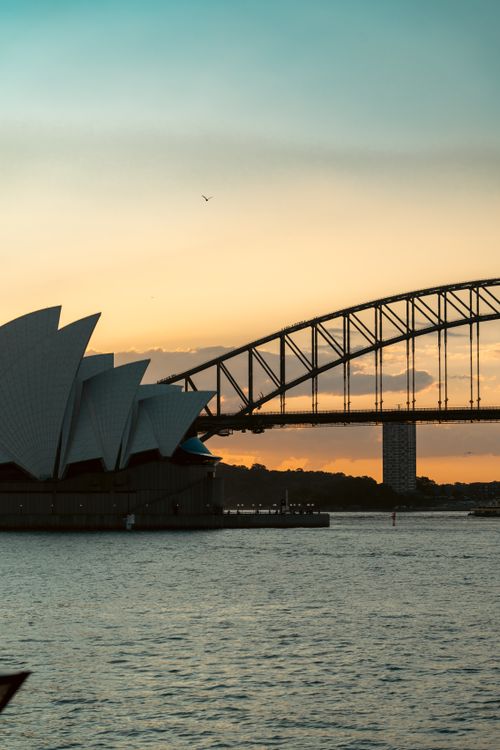 Free Breathtaking view of Sydney's iconic Opera House and Harbour Bridge during a stunning sunset. Stock Photo