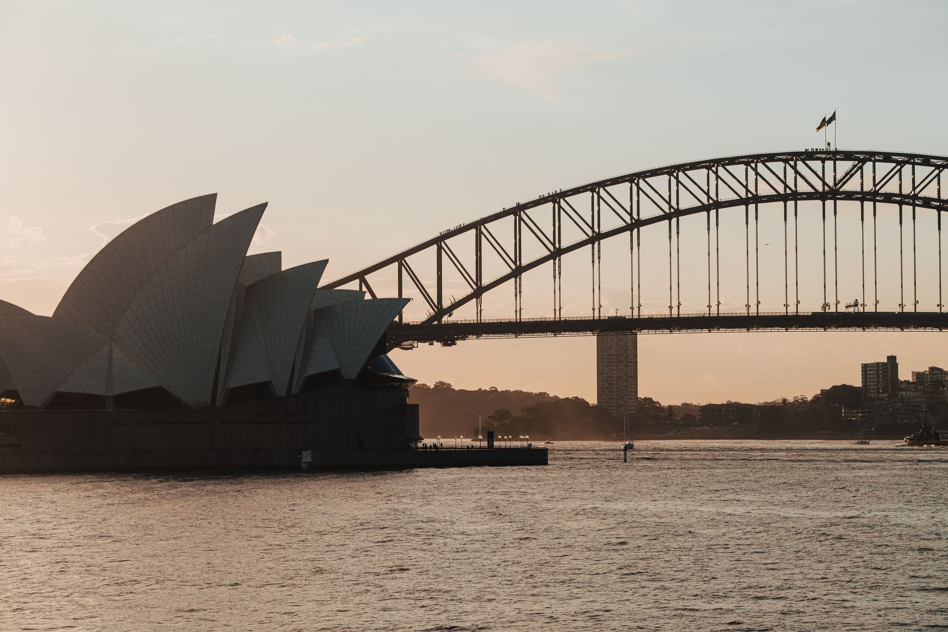 Sydney Opera House and Harbour Bridge at dusk over the harbour
