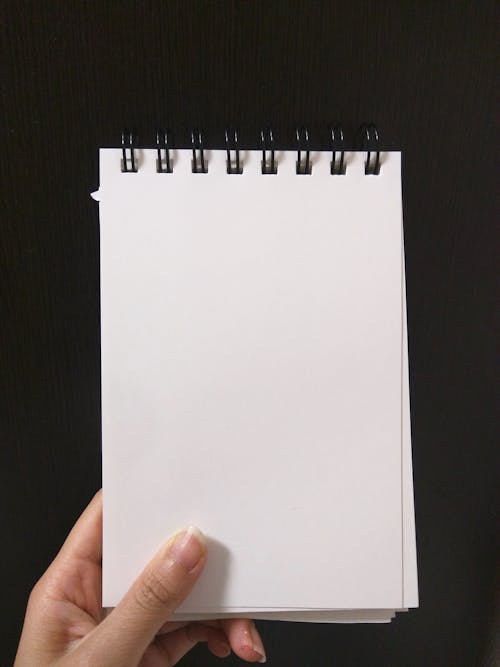 Free Person Holding Empty Notebook Stock Photo