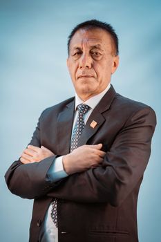 Photo by Bhandari Law and Partners Portrait of a confident businessman wearing a formal suit against a blue background.